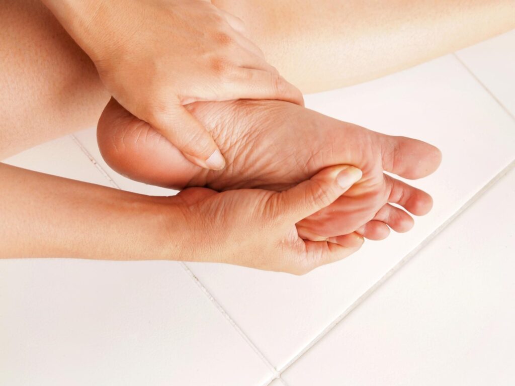 A Person Holding Their Foot in Hands