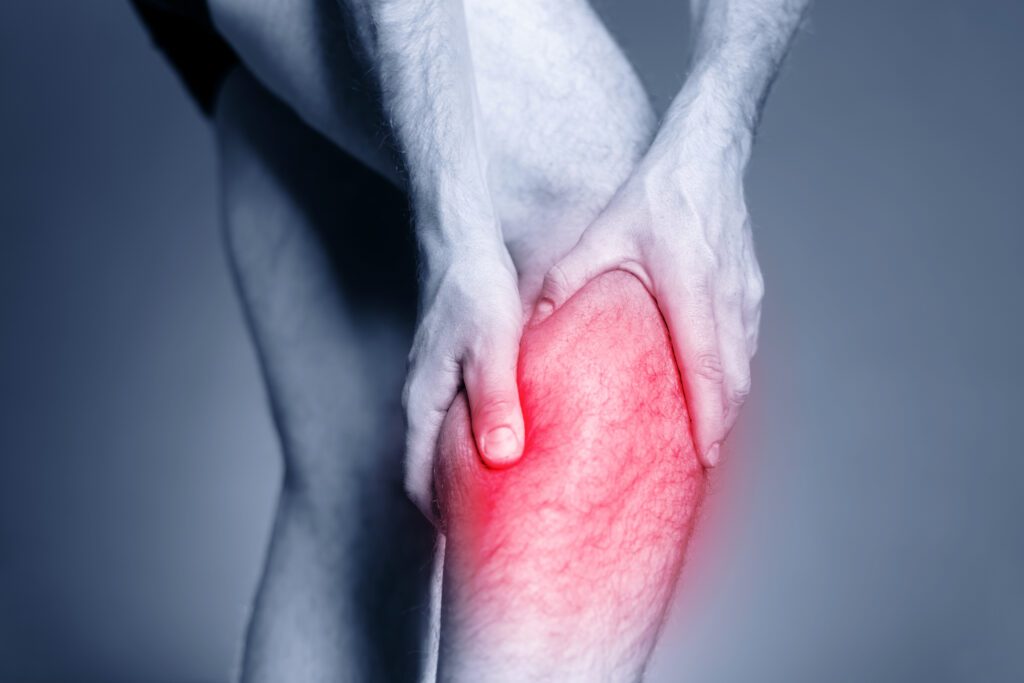 Calf leg pain, man holding sore and painful muscle, sprain or cramp ache filled with red pink bright place. Person injured when exercising or running