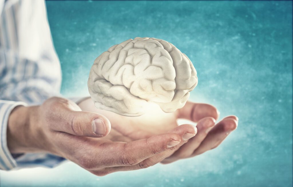 A Man Holding a Brain in Hands